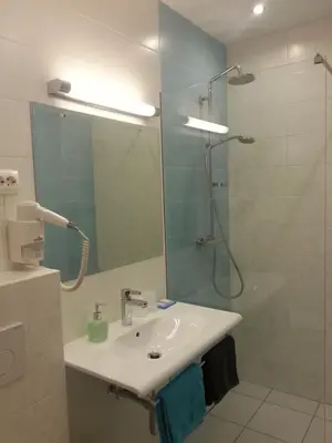 a bathroom with a sink and a shower at Penzion Tavcar in Ljubljana