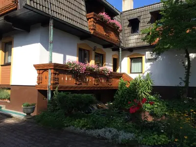 a building with a balcony with flowers on it at Penzion Tavcar in Ljubljana