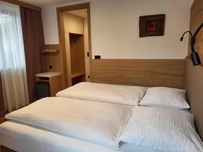 a bedroom with two beds with white sheets at Penzion Tavcar in Ljubljana