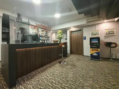 a lobby with a reception desk and a bar at Atelier Hotel in Ljubljana
