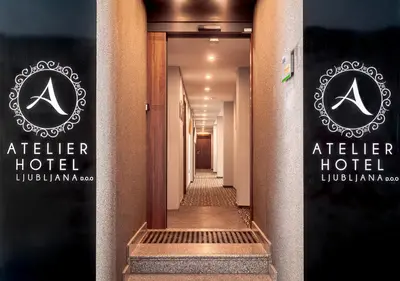 a hallway of a hotel with two signs on the door at Atelier Hotel in Ljubljana