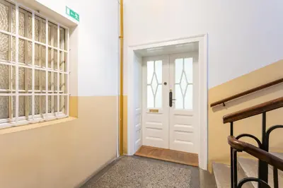 a hallway with a white door and a window at Urban Rooms--free parking-- in Ljubljana