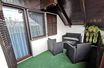 a room with two chairs and a table and a window at Apartment Countryside Kolpa-Bela krajina in Metlika