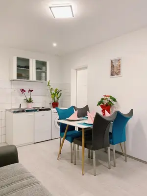 a kitchen and dining room with a table and chairs at Lina Rooms Hostel in Ljubljana
