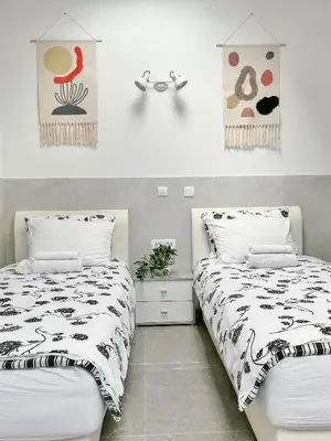 two beds sitting next to each other in a bedroom at Lina Rooms Hostel in Ljubljana
