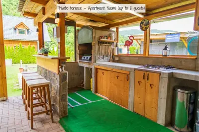 an outdoor kitchen with a counter and a stove at Apartmaji pri Jožu in Bohinj