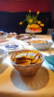 a table with a bowl of food on a table at Hotel Sporn in Radomlje