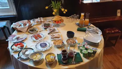 a table with plates of food on top of it at Hotel Sporn in Radomlje
