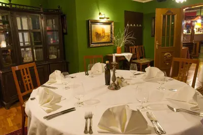 a table in a restaurant with a white table cloth at Hotel Sporn in Radomlje