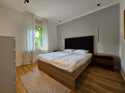 a bedroom with a large bed and a window at Hotel Sporn in Radomlje