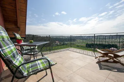 a patio with a table and chairs on a balcony at Tourism Tompa in Ljutomer