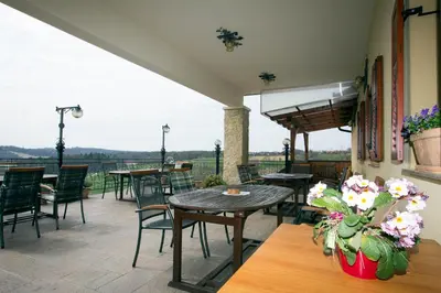 an outdoor patio with tables and chairs and flowers at Tourism Tompa in Ljutomer