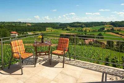two chairs and a table on a balcony with a view at Tourism Tompa in Ljutomer
