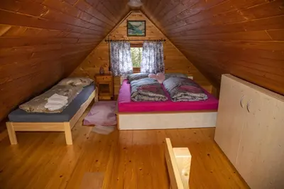 a bedroom with two beds in a log cabin at House Franja in Kranjska Gora