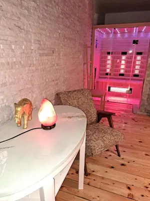 a table with a lamp on it next to a chair at House Franja in Kranjska Gora
