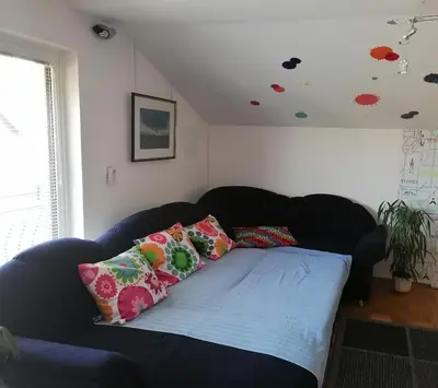a couch with pillows on it in a living room at at Marian's place in Spuhlja
