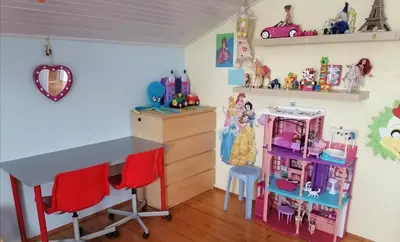 a childs room with a table and chairs and toys at at Marian's place in Spuhlja