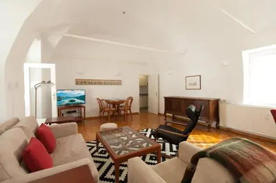 a living room with a couch and a table at Charming apartment Laura Tour As Ljubljana by Town Hall in Ljubljana