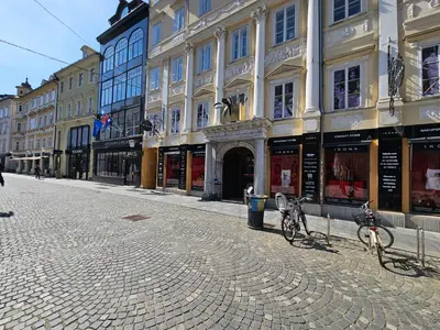 a cobblestone street with two bikes parked in front of buildings at Charming apartment Laura Tour As Ljubljana by Town Hall in Ljubljana