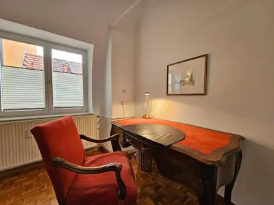 a room with a desk and a chair and a table at Charming apartment Laura Tour As Ljubljana by Town Hall in Ljubljana