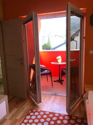 a door leading into a room with a table at Perfect Apartma - Apartments - Free parking! in Maribor