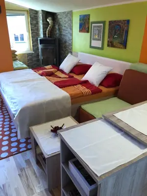 a room with two beds and a couch and a table at Perfect Apartma - Apartments - Free parking! in Maribor