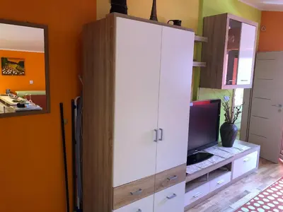 a large white cabinet with a television in a room at Perfect Apartma - Apartments - Free parking! in Maribor