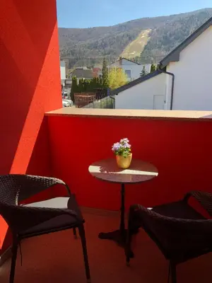 a small table and two chairs on a balcony at Perfect Apartma - Apartments - Free parking! in Maribor