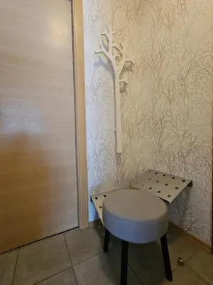 a stool in front of a wall with a tree on it at Apartments Supermjau in Bovec