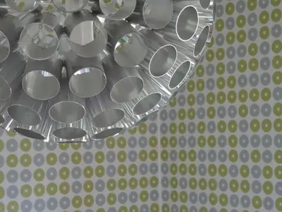 a bunch of silver plates on a metal surface at Apartments Supermjau in Bovec