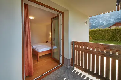 a balcony with a door leading to a bedroom at Rute Hotel and Apartments in Kranjska Gora