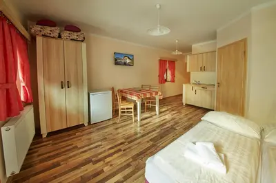 a bedroom with a bed and a table in it at Rute Hotel and Apartments in Kranjska Gora