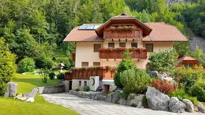 a house with a garden in front of it at Apartma in Bungalov Jezerci in Gozd Martuljek