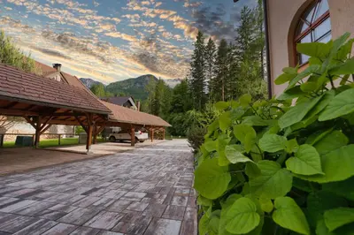 a brick walkway in front of a building at Apartma in Bungalov Jezerci in Gozd Martuljek
