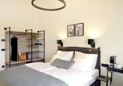 a bedroom with a bed with a mirror above it at Hotel Maribor & Garden Rooms in Maribor