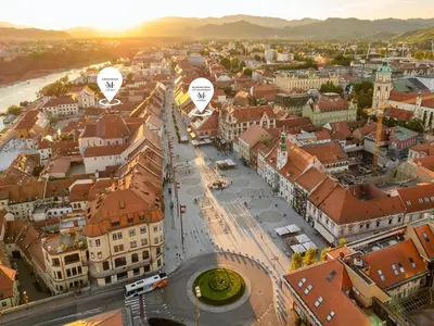 an aerial view of a city with buildings and white bubbles at Hotel Maribor & Garden Rooms in Maribor