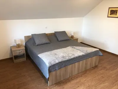 a bedroom with a large bed with two night stands at Apartments Magdalena in Radovljica