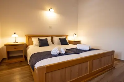 a bedroom with a bed with two towels on it at Kraška hiša Škrla in Divača