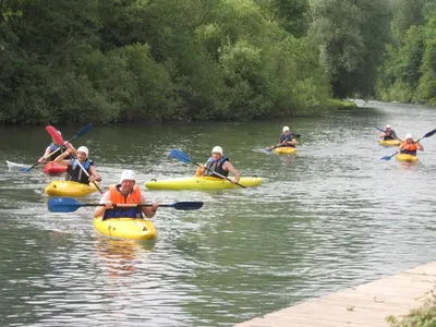 a group of people kayaking on a river at Šport center Prodnik in Ljubno