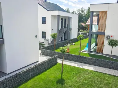 an image of a house with a retaining wall at Apartma Mariposa Banovci in Banovci