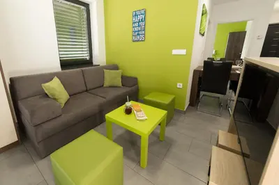 a living room with a couch and a table at Apartma Mariposa Banovci in Banovci