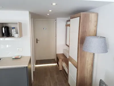 a small kitchen with a desk and a lamp at SIPPO Apartments in Ljubljana