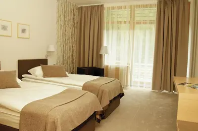 a hotel room with two beds and a window at Špik Alpine Resort in Kranjska Gora