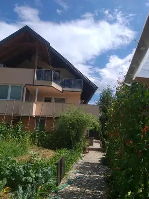 a house with a balcony on the side of it at Apartma Metka Leše Tržič in Leše