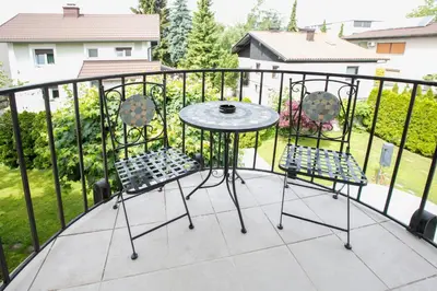 a patio table and chairs on a balcony at Vila Marija in Ljubljana