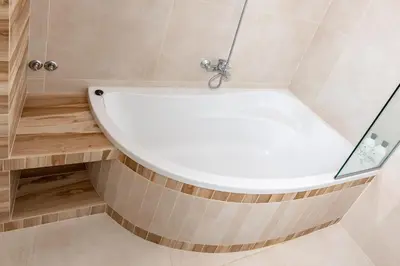 a bathtub in a bathroom with a glass wall at Vila Marija in Ljubljana