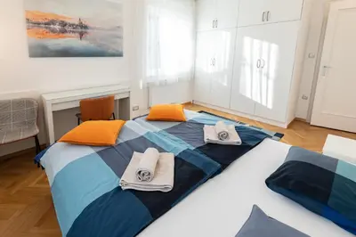 a bedroom with a large bed with towels on it at Vila Marija in Ljubljana