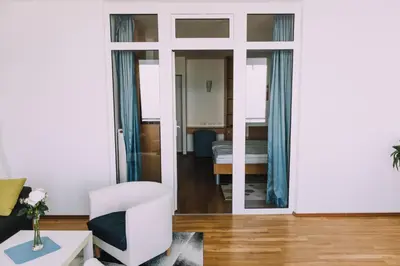 a living room with a door leading to a bedroom at Hotel Bellevue in Kranj