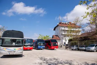 a group of buses parked in a parking lot at Hotel Bellevue in Kranj