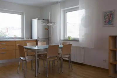 a kitchen with a table and chairs and a refrigerator at Vacation Home Sofia in Zgornje Gorje